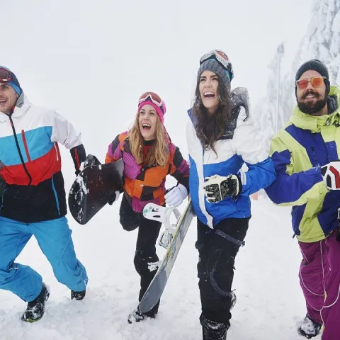 two-couples-having-fun-snowboarding